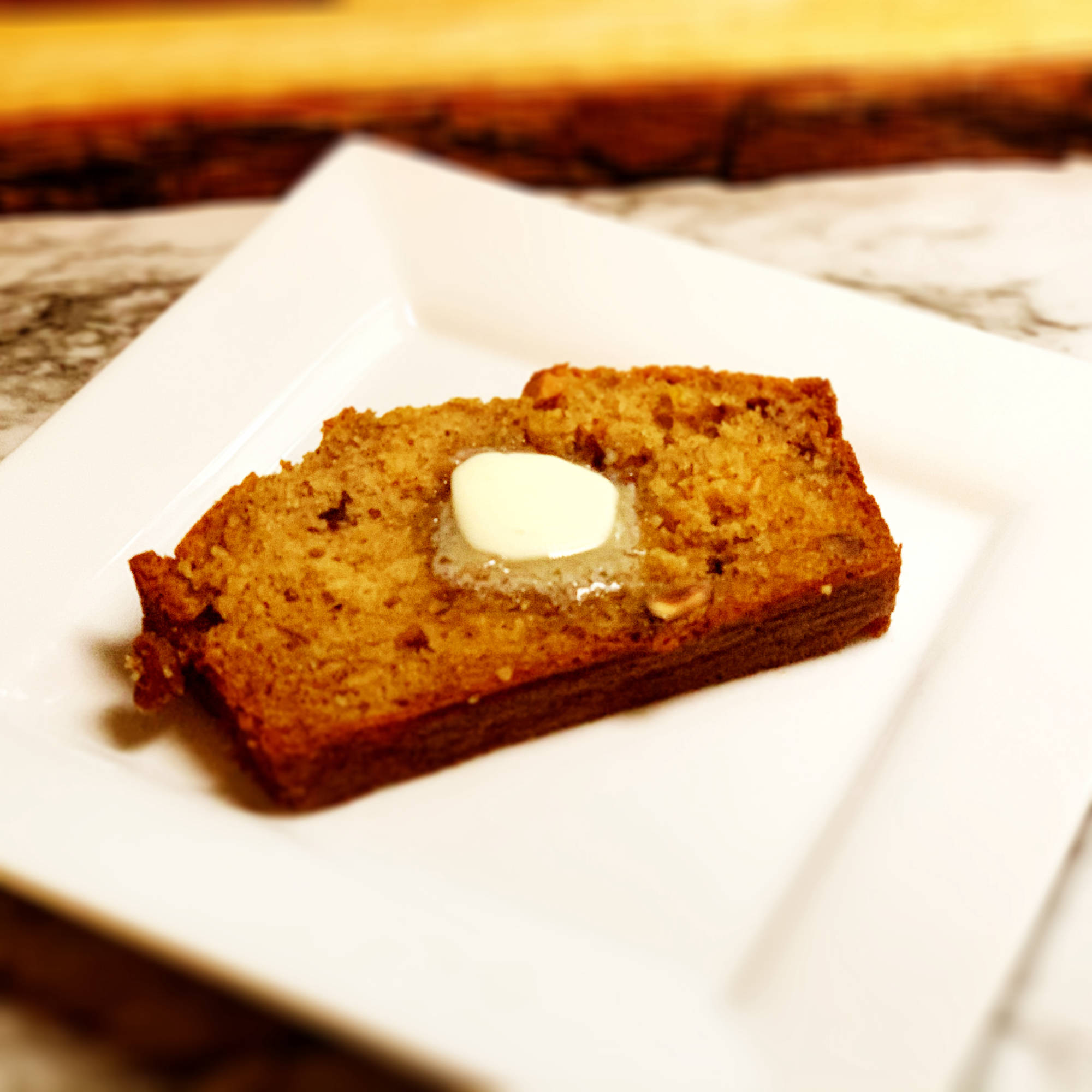 Photo of slice of banana bread with melting butter