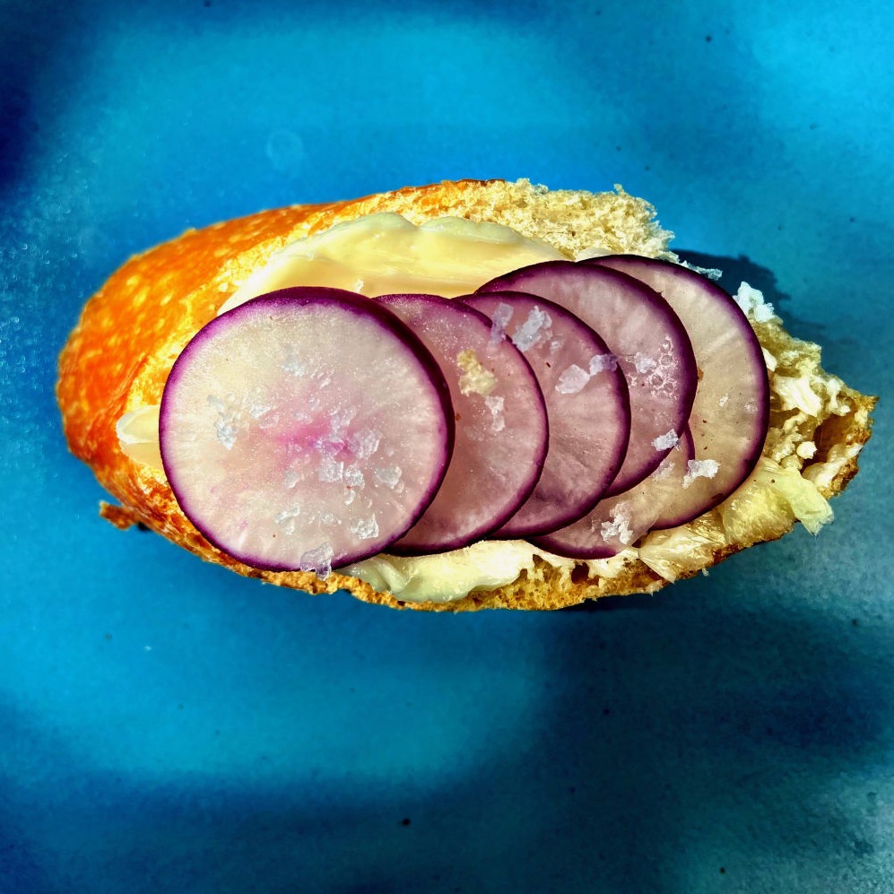 Photo of sliced radishes on butter and bread